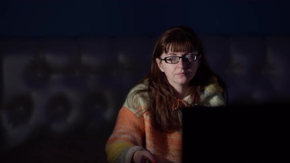 Woman with a Glass of Wine Watches Tv in the Evening at Home