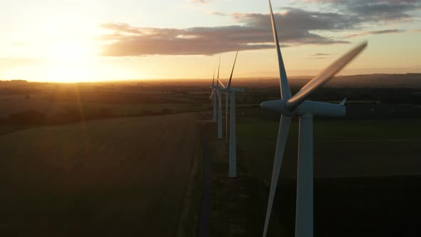 Four wind turbines at sunrise