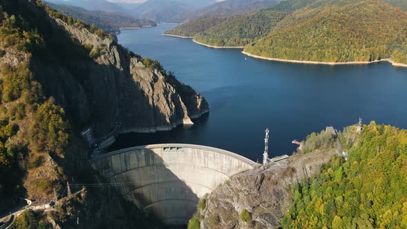 Aerial drone view of nature in Romania. Valley in Carpathian mountains with Vidraru dam and lake alt