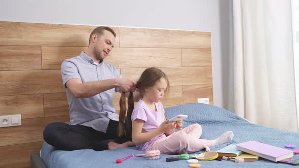 Young Father Brushing and Braiding Cute Little Daughter Hair Enjoy Spending Time Together at Home