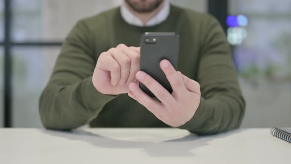 Close Up of Young Businessman Using Smartphone alt