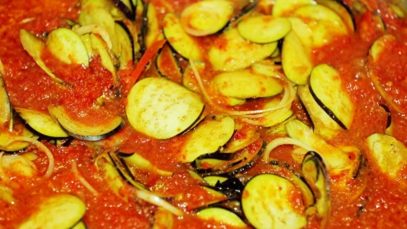 Chef Adding Eggplants Into Spicy Eastern Meal