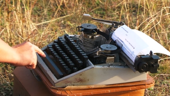 Woman Typing On Vintage Typewriter At Nature