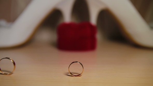 Two Wedding Rings Rolling On The Table