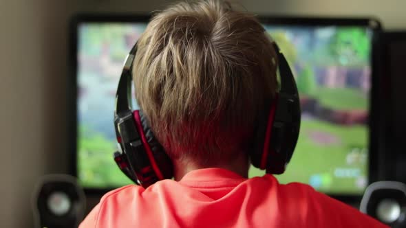 Young Boy Gaming Online Wearing Headphones Battle Royale