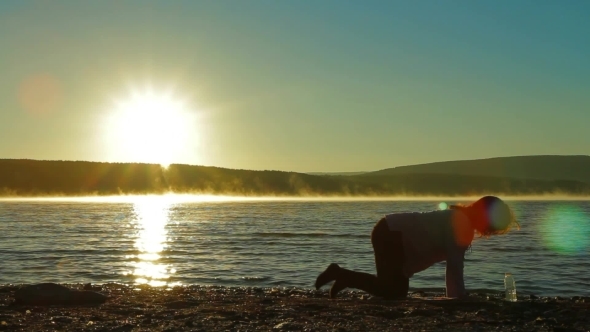 Pregnant Woman At Dawn Doing Exercise. alt