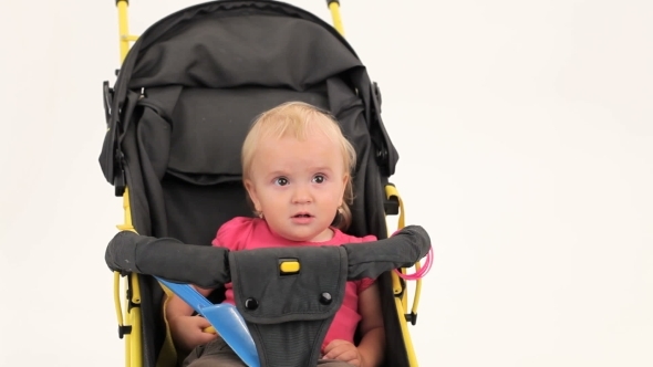 Little Girl Sitting In Pram And Smiling