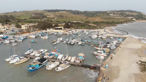 Drone footage of Boats moored at the harbor of Marsaxlokk, Malta alt