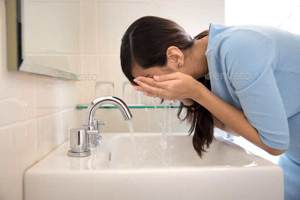 Asian woman washing her face on the sink Stock Photo by odua | PhotoDune