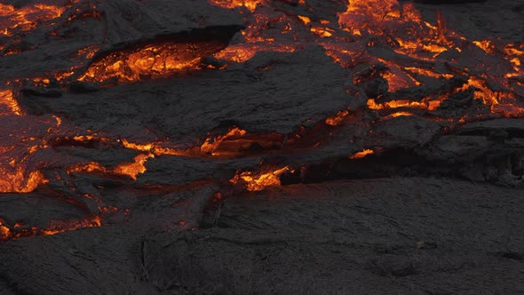 Incredible view of masses of earth moving as river stream of glowing lava flows alt