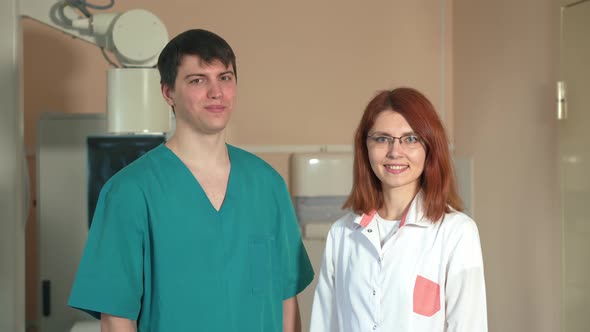 Portrait of Smiling Two Doctor Satisfied with His Job in a X-ray Room