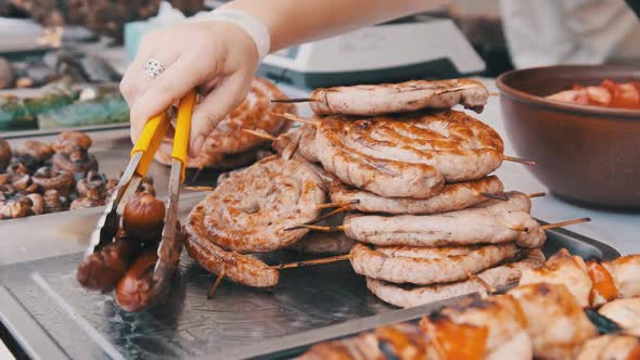 Ready-to-Eat Grilled Meat in a Street Food Shop Window. Ready-made Food on Party alt