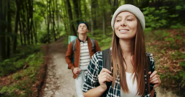 Backpacked Couple Walking in Forest