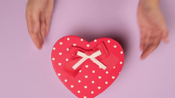 heart shaped cardboard gift box on a purple background