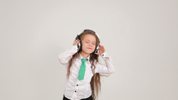 Small Cute Girl Listening To Music With Headphones