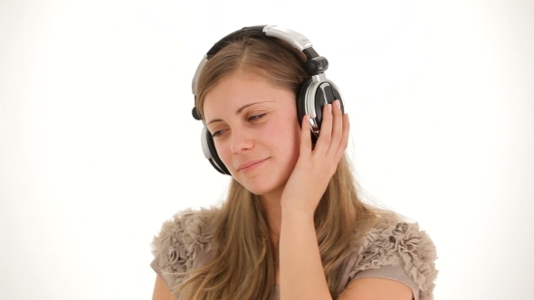 Young Pretty Lady In Earphones Listening To Music