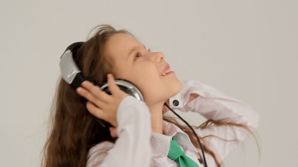 Portrait Of Little Girl Listening To Music With