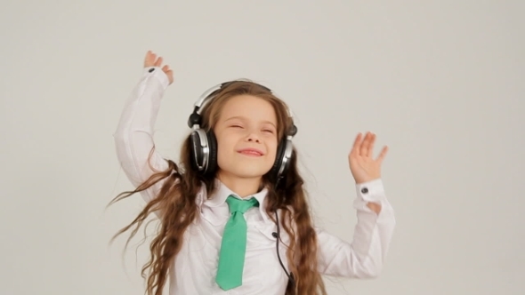 Little Girl Listening To Music With Headphones And