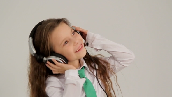 Little Girl Listening To Music With Headphones And