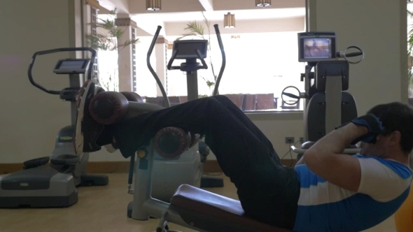 Man Doing Abs Exercise In The Gym alt