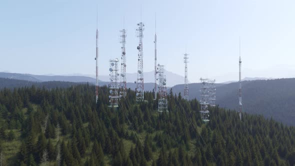Antennas complex on a forested hill. Radio masts and towers for broadcasting. alt