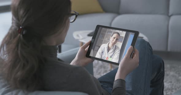 Online doctor giving a consultation to a patient at home