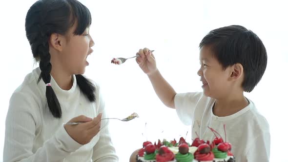 Asian Brother Feeding A Cake For His Sister