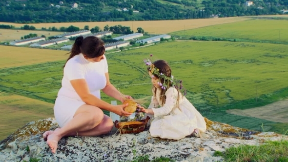 Mother With Little Daughter Having Lunch At Nature