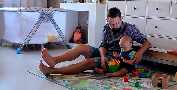 Father Playing with a Small Child in the Nursery