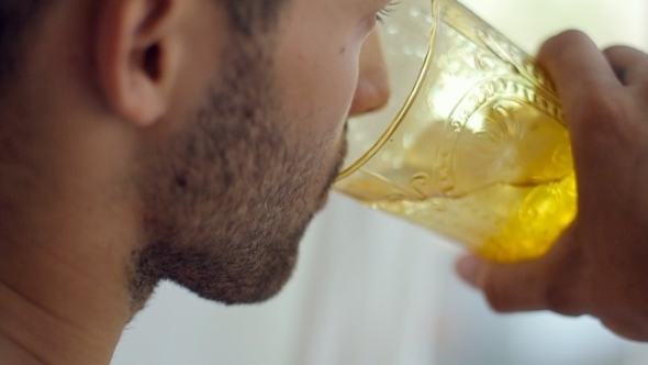 Bearded Man With a Tattoo Drink Iced Drink From a