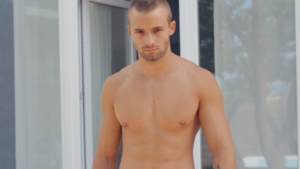 Brutal Naked Guy With a Beard And a Tattoo Comes