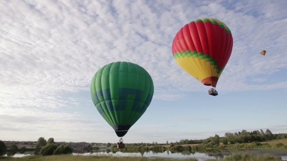 Hot Air Balloons Flying Over Lake And Field Hot Air Balloons Flying Over Lake And Field
