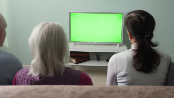 Family Watching TV. Green Screen. alt
