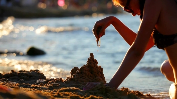 Girl On The Sea Builds a Sand Castle Girl On The Sea Builds a Sand Castle