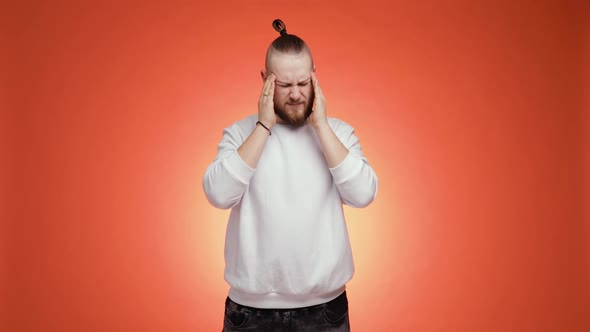 Sick Ill Bearded Man in White Sweater Putting Hands on Head Having Headache alt