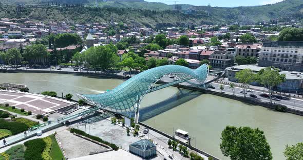 Aerial view of Tbilisi city central park and Bridge of Peace. Beautiful cityscape of old Tbilisi at alt
