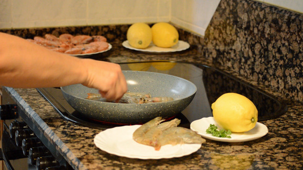 Frying Raw Shrimp Placing It On A Pan Frying Raw Shrimp Placing It On A Pan