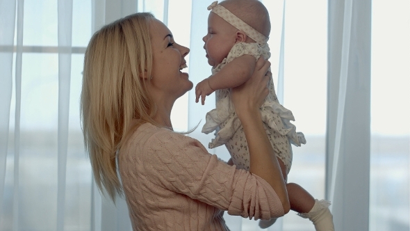 Happy Family Mother Throws Up And Kissing Baby Happy Family Mother Throws Up And Kissing Baby