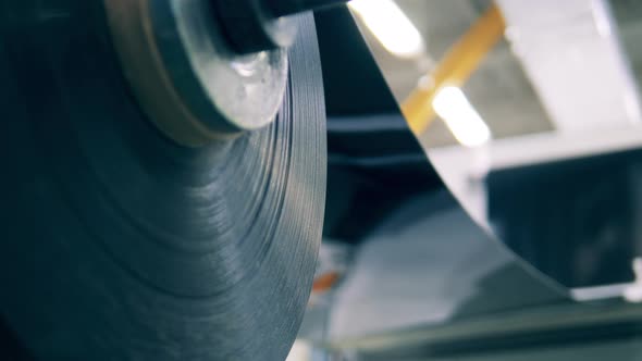 A Reel with Plastic Material Is Moving Slowly alt