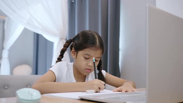 Kid girl school studying online from home watching web class lesson by video call elearning.  alt