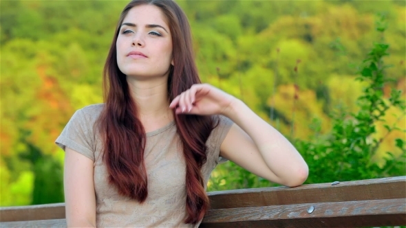 Portrait Of a Beautiful Girl Sitting On a Bench Portrait Of a Beautiful Girl Sitting On a Bench