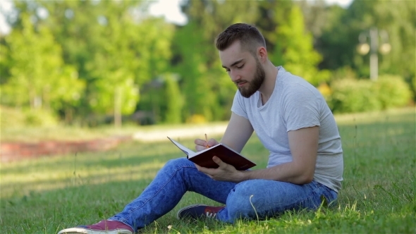 Young Man Sitting In The Park With His Diary by photo_oles ...