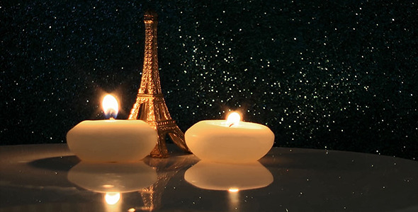 Eiffel Tower with Candles on Glittering Background