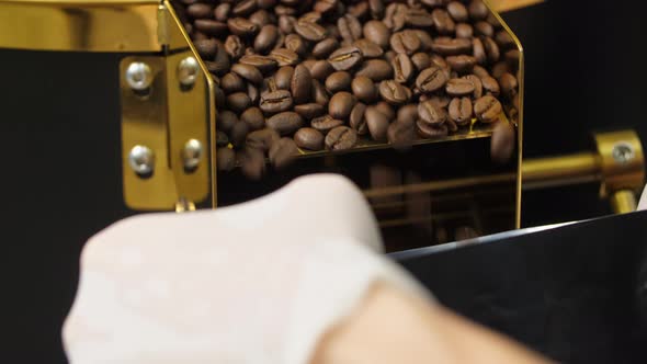 Unrecognizable Worker Holding Bag And Filling It With Coffee Beans alt