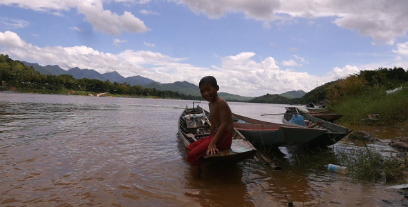 Little Boy Sitting On A Boat Little Boy Sitting On A Boat