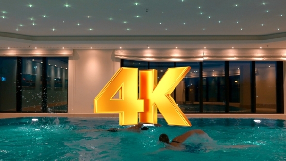 Man And Woman Swimming In The Indoor Pool Man And Woman Swimming In The Indoor Pool