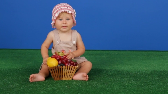 Girl Holding Grapes On A Blue Background Girl Holding Grapes On A Blue Background