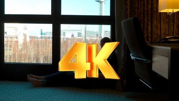 Woman Uisng Laptop By The Window In Hotel Room Woman Uisng Laptop By The Window In Hotel Room