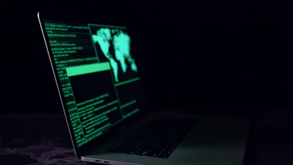 Hacker Concept. Code On A Laptop Computer Monitor In A Dark Room alt