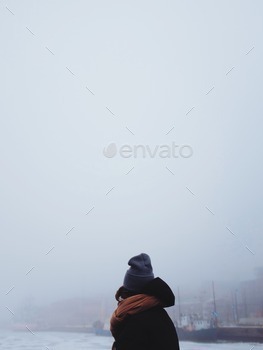 Woman framed agains a foggy sea view
